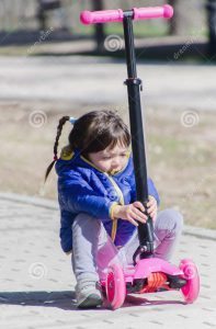 kids sitting on scooter